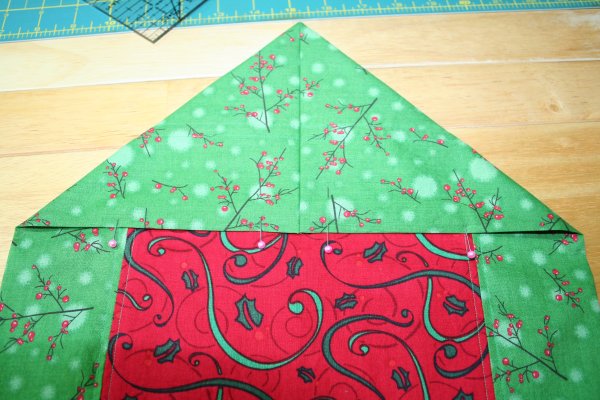 Pin, centering seam in center of second fabric