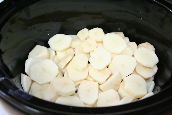 Layer sliced potatoes in bottom of slow cooker