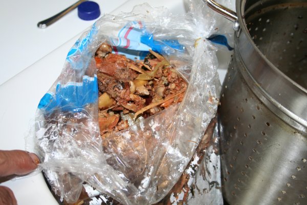 Put bones and cooked veggies, etc in plastic bag and put in garbage