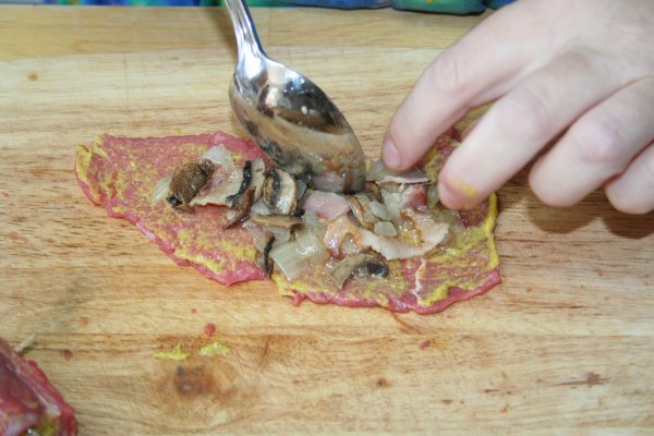 Spoon on bacon, onion, mushroom mixture