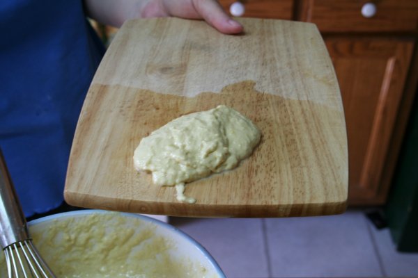 Place large spoonful on wet cutting board