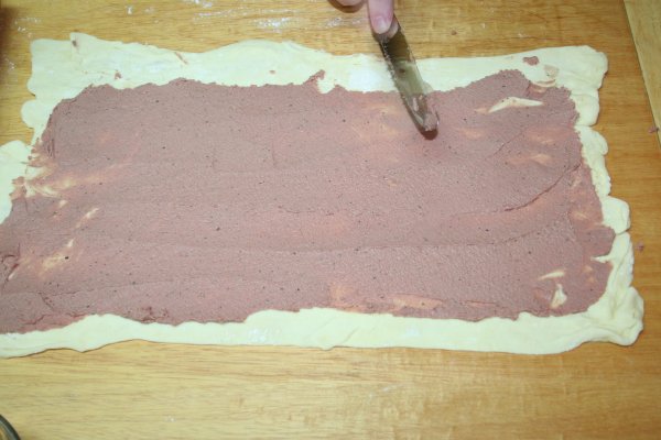 Spread pate on puff pastry