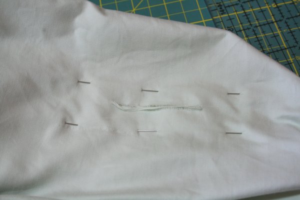 Once pinned and before starting to sew, it's a good idea to turn the sheet over to make sure that the tear is centered on the patch.