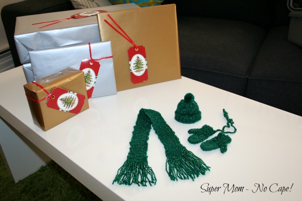 Mini Mittens Hat and Scarf with wrapped gifts in the background