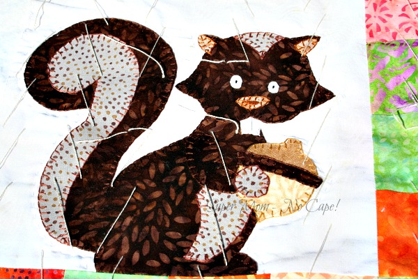 Hand quilting around the appliqued squirrel.