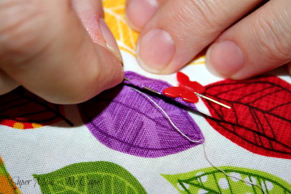 Take a stitch in the pressed edge of the second section.