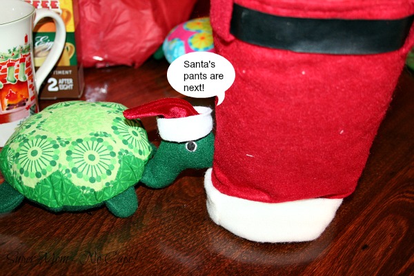 Photo of Rexie pushing the Santa pants gift bag