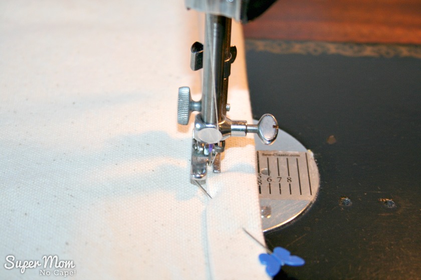 Sewing close to the folded edge to hem the Painted Maple Leaf Table Runner