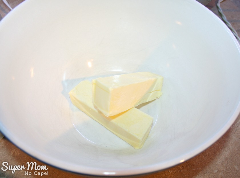 Two sticks of butter in a large mixing bowl.