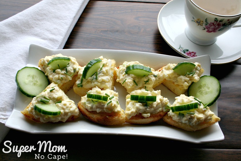 10 Delicious Ways to Use Boiled Eggs - Egg Salad served on toasted English muffins quartered and topped with sliced quartered cucumber slices