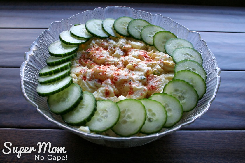Potato Salad to Feed a Crowd - Potato salad in a pretty bowl ringed with cucumbers and sprinkle with paprika