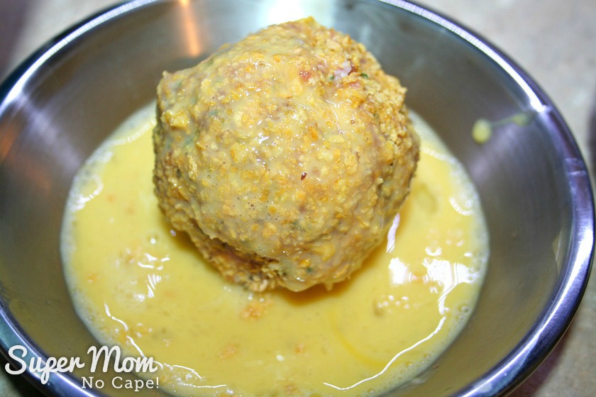 Gluten Free Baked Scotch Eggs - returned coated scotch egg to egg mixture