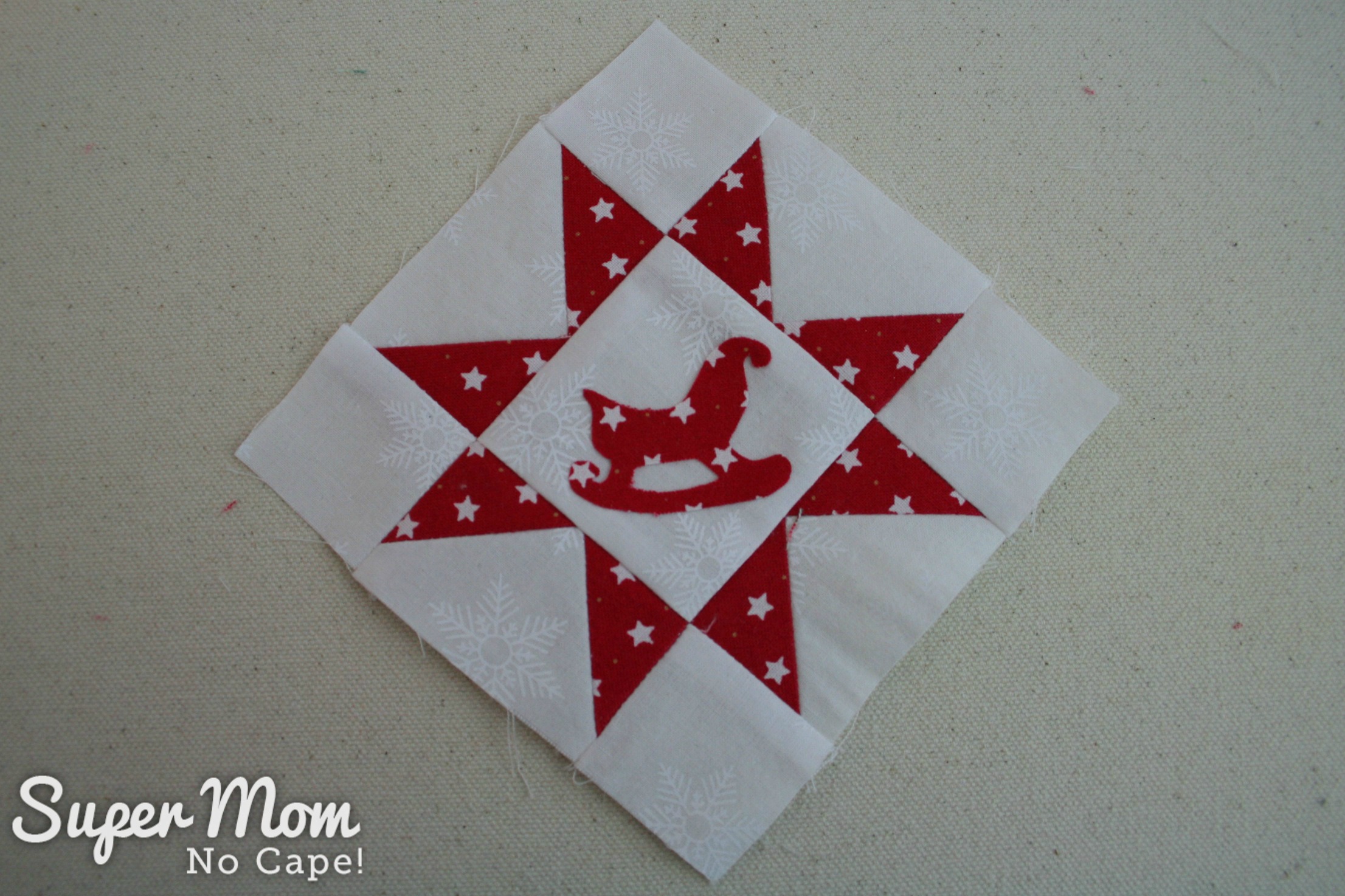 Sawtooth Star with Applique Center Ornament 28. Place star block on point and fusible the shape in place