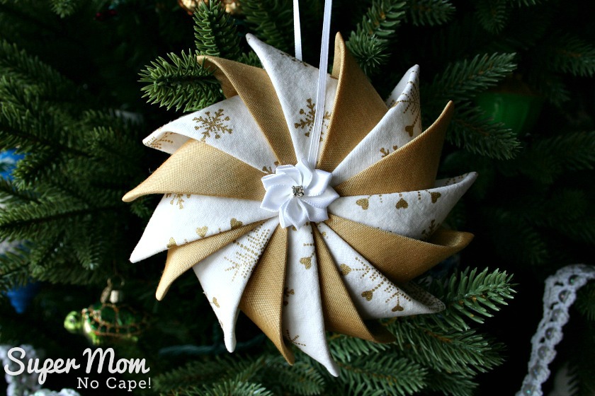 Gold and white Prairie Point Star Ornament with pretty ribbon flower center