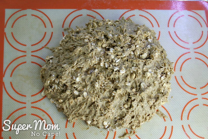 Ball of oatmeal covered Irish Soda Bread Dough transfered to silpat lined baking sheet