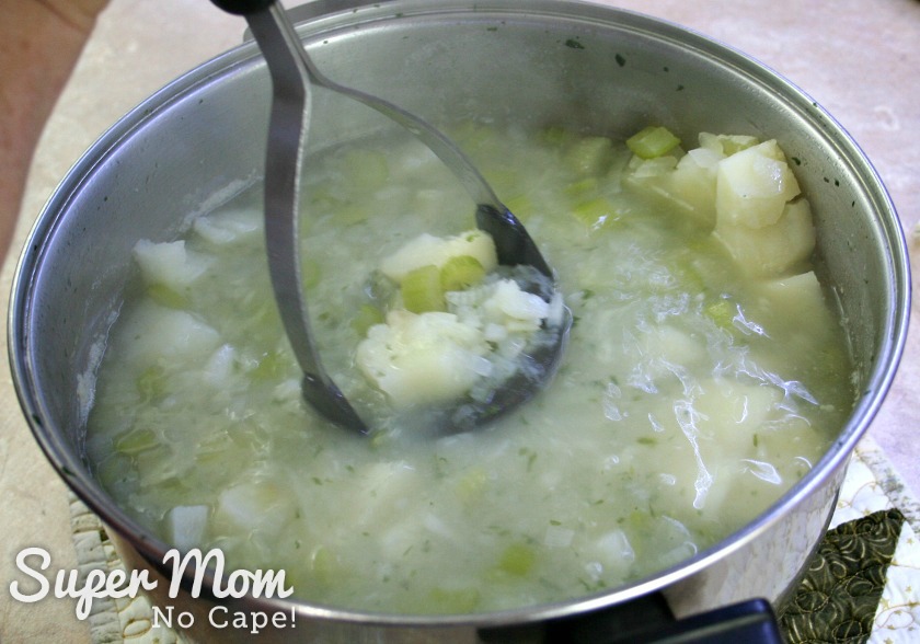 Mashing potatoes in the pot of Luck of the Irish Potato Soup