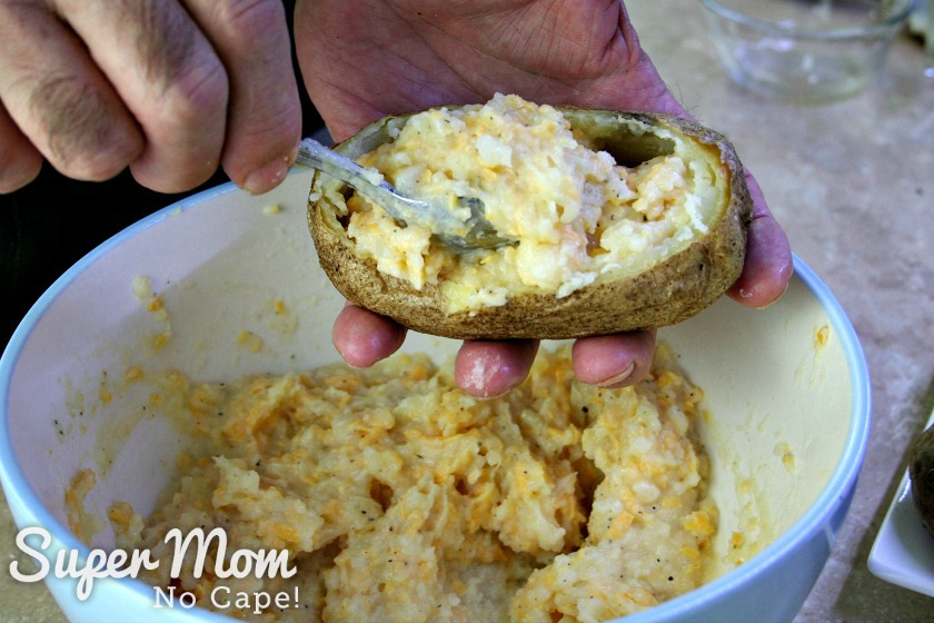 Scooping potato mixture into shells for Twice Baked Potatoes