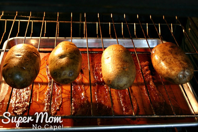 Potatoes baking on rack in oven