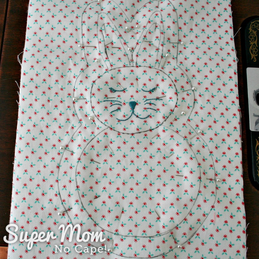 Photo of the traced bunny pinned to the layers of the batting and backing fabric