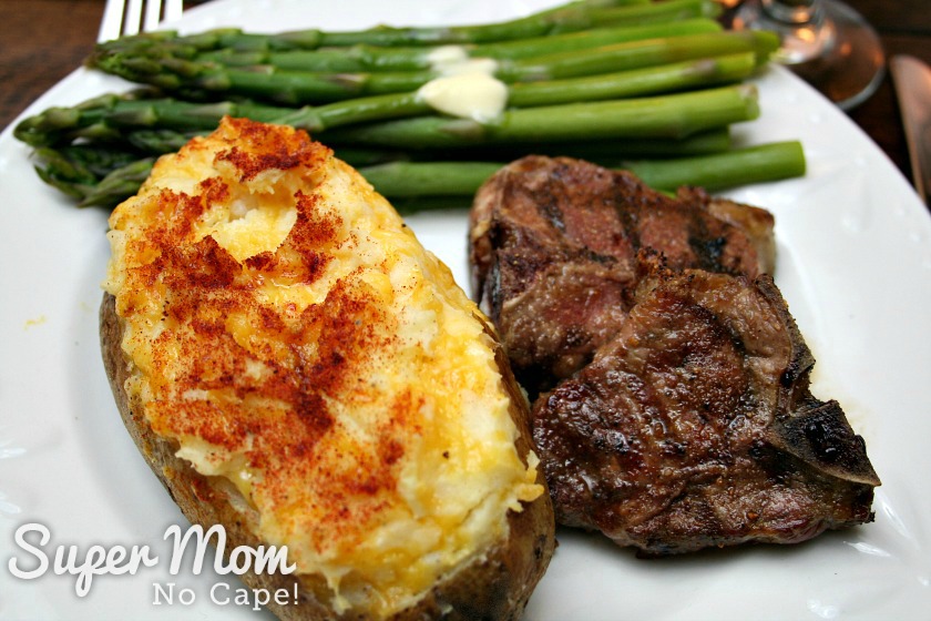 Twice Baked Potato served with grilled lamb chop and asparagus