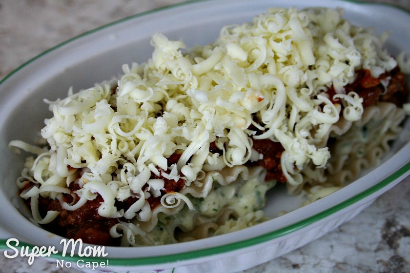 Make these Easy Lasagna Roll Ups for supper tonight or freeze them to have for those nights when life gets a little crazy and you don't have time to cook. Freezer cooking is a sanity saver and this recipe is a family favorite that you'll want to make again and again. #recipes #freezercooking #lasagnarecipes #lasagna #pastarecipes Two Lasagna Roll Ups in casserole dish ready to bake