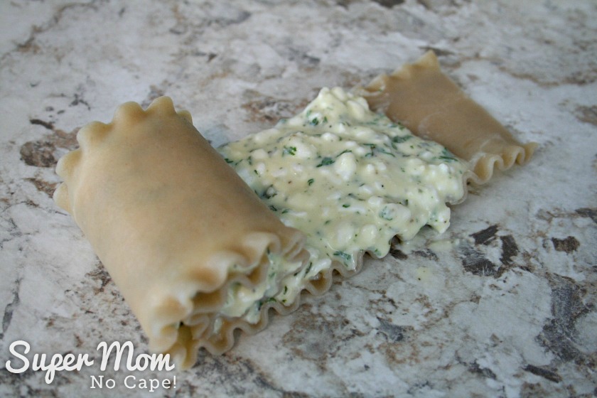 Make these Easy Lasagna Roll Ups for supper tonight or freeze them to have for those nights when life gets a little crazy and you don't have time to cook. Freezer cooking is a sanity saver and this recipe is a family favorite that you'll want to make again and again. #recipes #freezercooking #lasagnarecipes #lasagna #pastarecipes Partially rolled Lasagna Roll Up