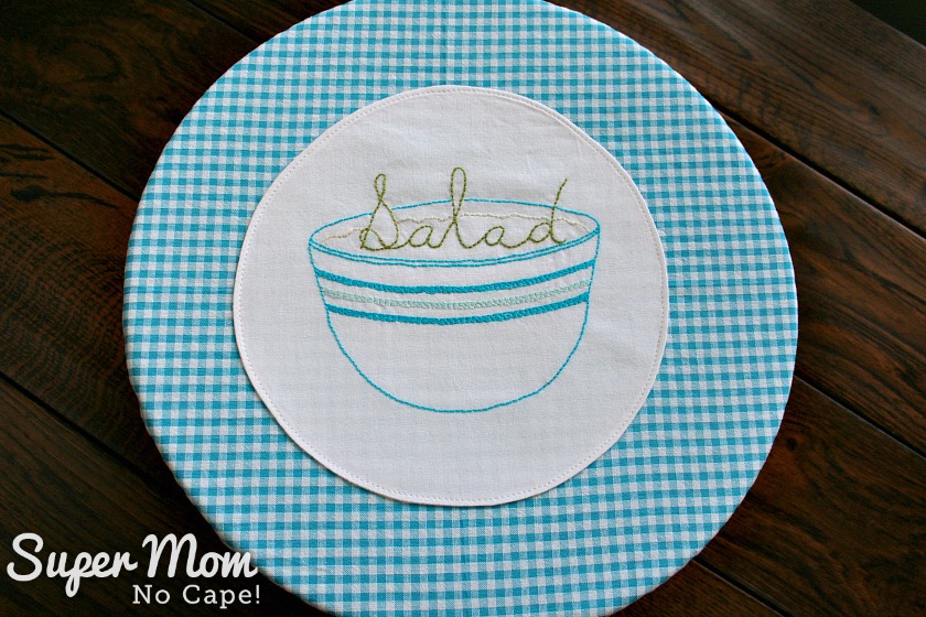 Salad Embroidery Pattern stitched on white fabric applied to gingham fabric