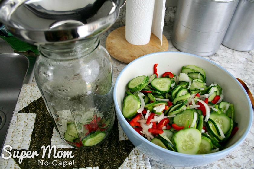 Adding ingredients for Refrigerator Pickles to half gallon mason jar
