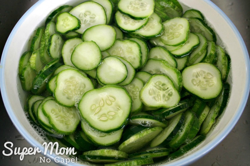 Sliced cucumbers covered with filtered water in a large bow
