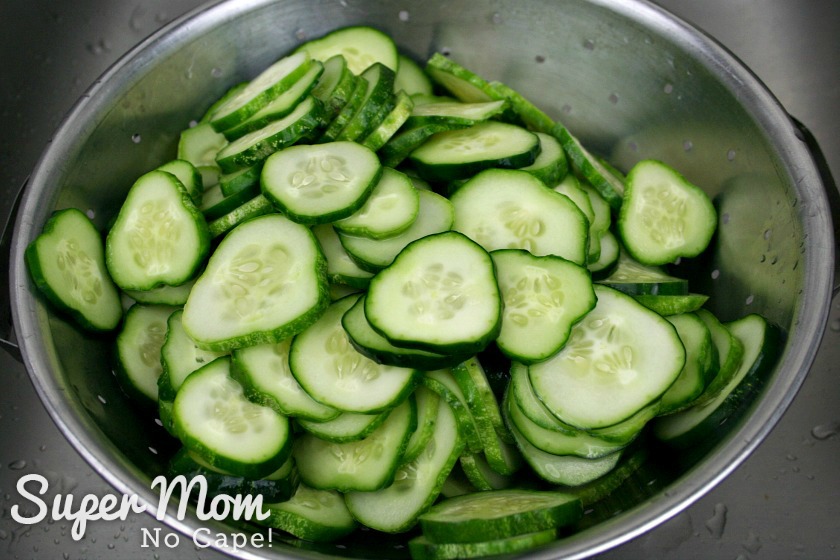Sliced cucumbers for Refrigerator Pickles draining in colander
