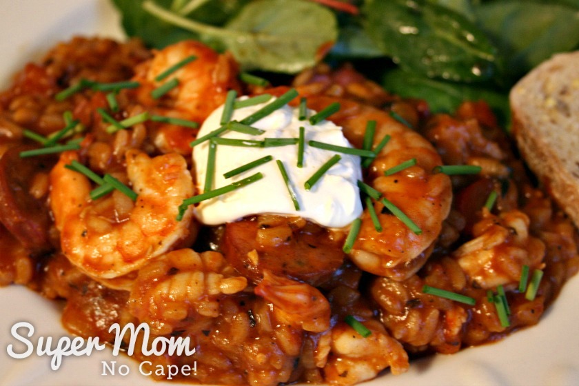 Close up of Jambalaya served with bread and salad