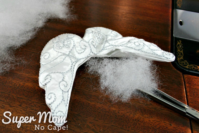  Use surgical clamp to insert filling into the Embroidered Angel Wings