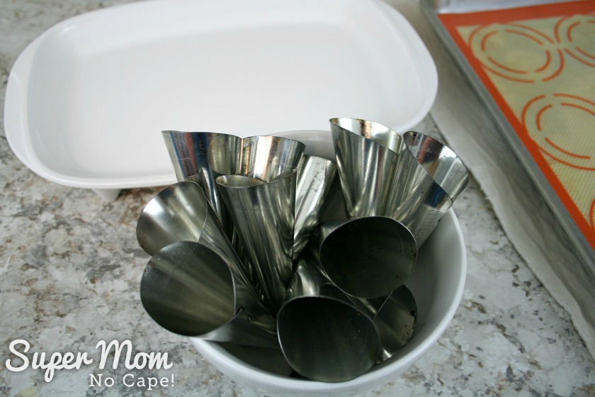 12 Metal pastry horns in a white bowl