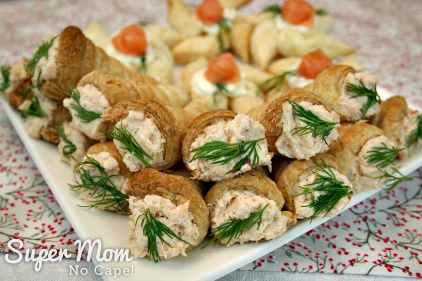 Mini Puff Pastry Cone Appetizers filled with Sweet Chili Shrimp Dip garnished with a sprig of fresh dill weed
