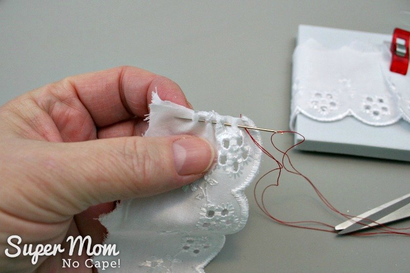 Sewing the short ends of the eyelet lace together for the Christmas Button Lace Ornament