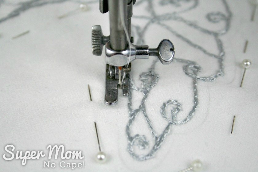 Stitching one eighth inch away from the embroidery