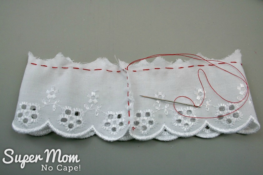 Gathering stitch sewn at the top of the eyelet lace to make a Christmas Button Lace Ornament