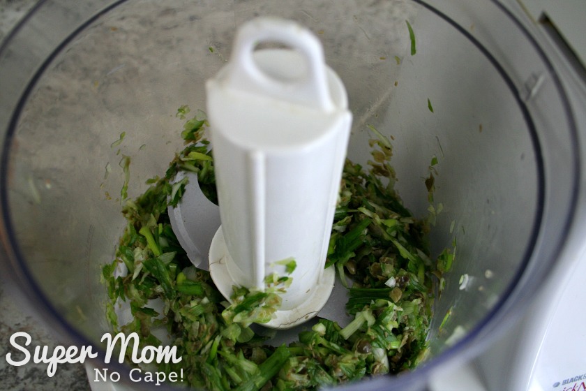 Chopping the green onion and capers in the food processor to make Caper Snacks