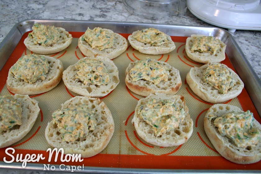 Adding a spoonful of caper mixture to the english muffins for Caper Snacks