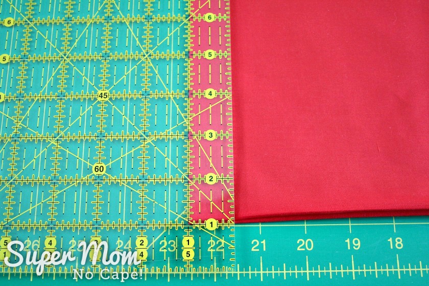 Measuring to cut one inch strips of fabric for the Poke and Push Fabric Christmas tree