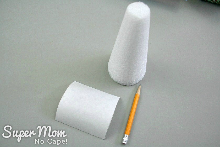 Square of freezer paper, pencil and Styrofoam cone