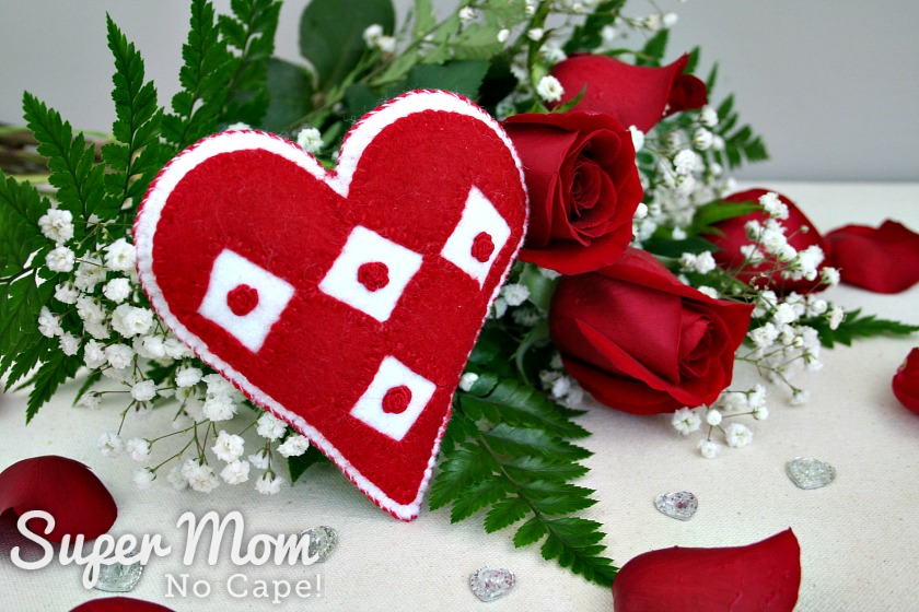 Photo of the I Heart Diamonds and Roses sachet with a bouquet of red roses in the background