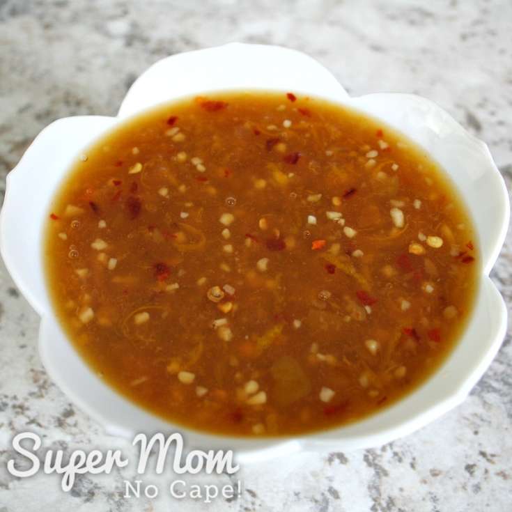 Bowl of homemade orange sauce set aside to cool