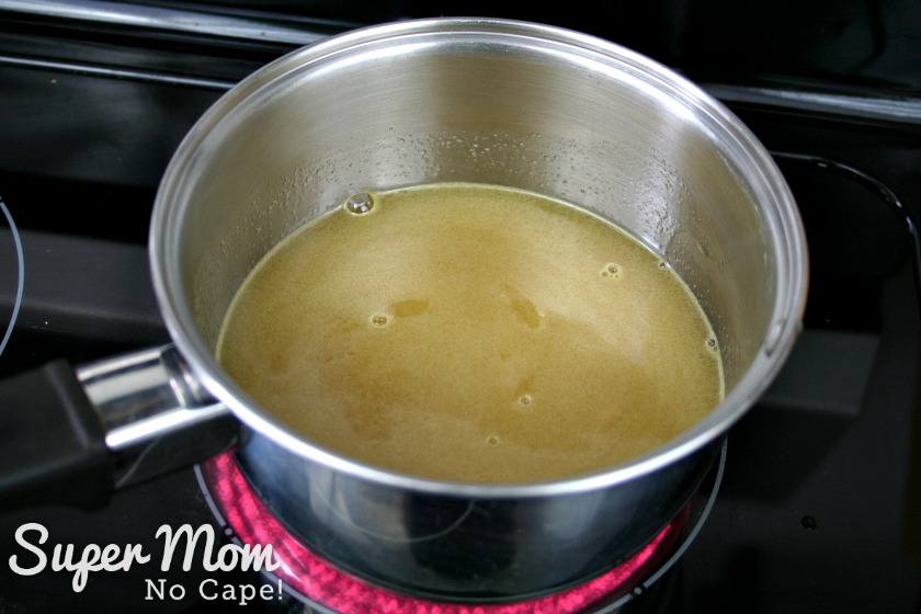 Orange juice and sugar heating in a small sauce pan