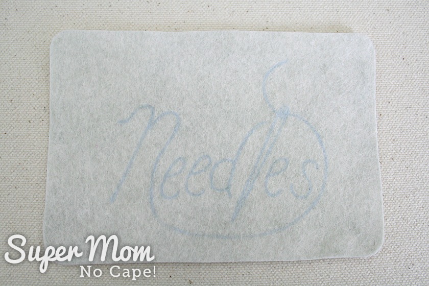 Embroidery pattern for the word Needles transferred to felt needlebook cover