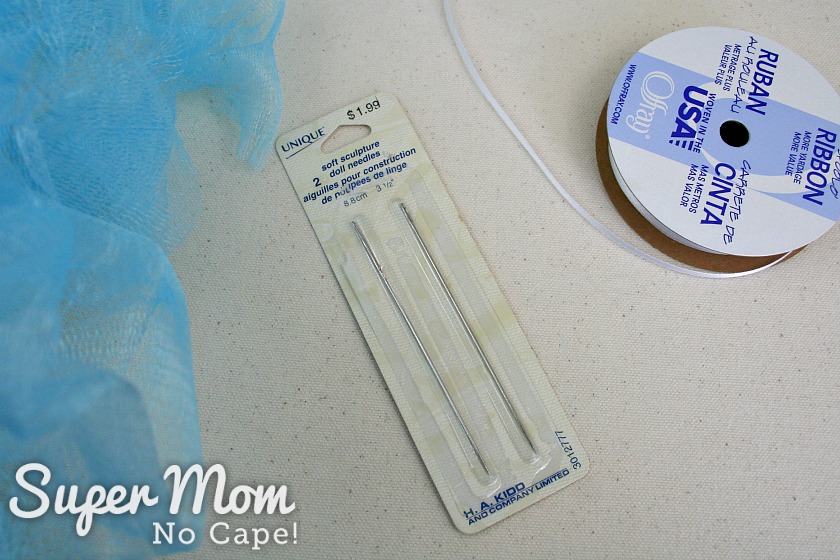 Package of 2 soft sculpture needles and a roll of eighth inch ribbon