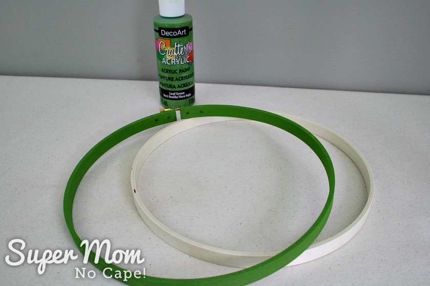 Embroidery hoop that has been painted green using DecoArt paint
