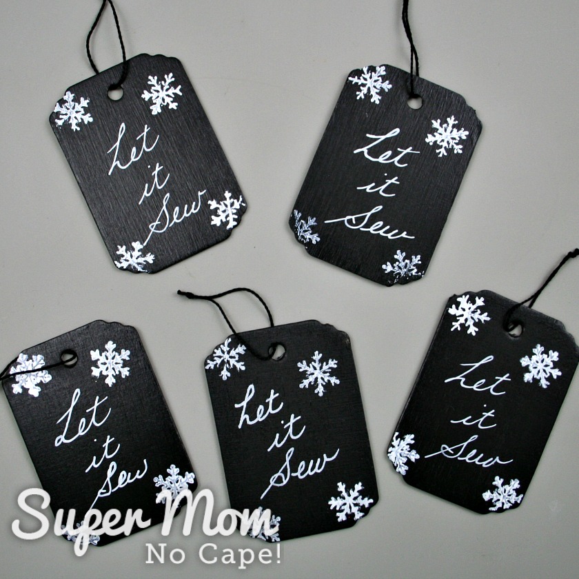 Five Let it Sew tags with white snowflakes