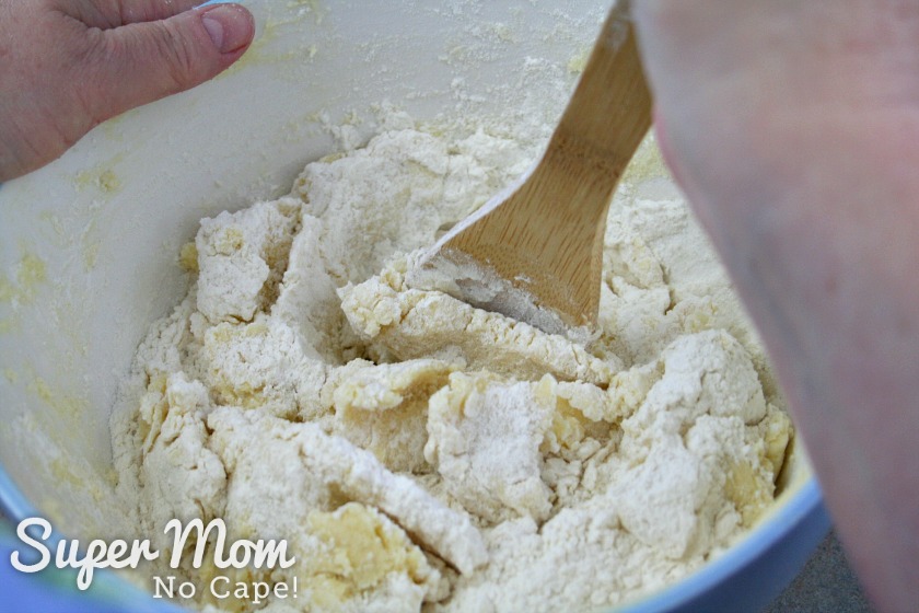 Kneading the flour into the butter mixture using a wooden spoon
