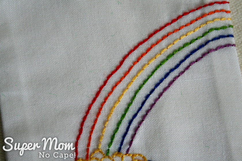 Embroidered rainbow over pot of gold